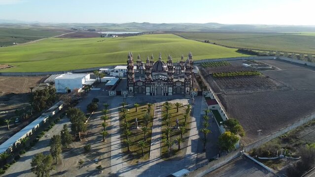 Main entrance of the Palmar de Troya Cathedral. Homequarters of an illegal and polemic sect. Aerial shot. A huge epic building in the middle of nothing. Protect with walls and security wires.