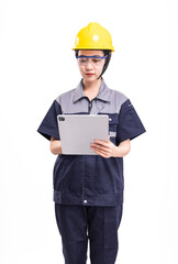 A female worker in a hard hat and uniform holding a computer