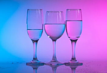 Wine glasses with neon multicolor light