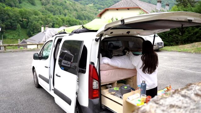 digital nomad traveller woman cooking dinner in her camper car van