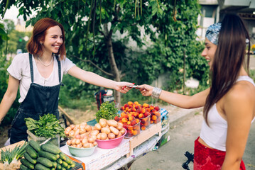 Seller woman offers fresh and organic vegetables farmers market.