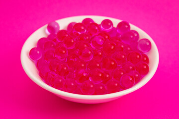 Bowl of Popping Boba Pearls on a Bright Pink Background