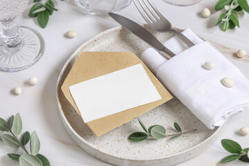 Elegant Table setting with a card decorated with eucalyptus branches close up, Wedding mockup