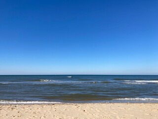 the calm sea with blue sky and sandy beach
