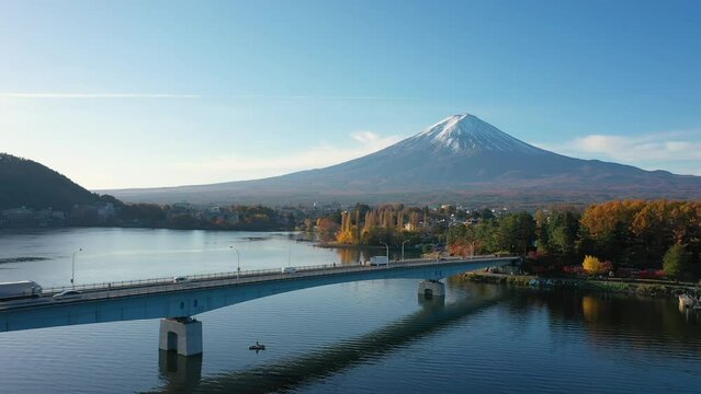 Aerial view 4k video by drone of Mount Fuji and bridge at Kawaguchi lake, Japan on morning.