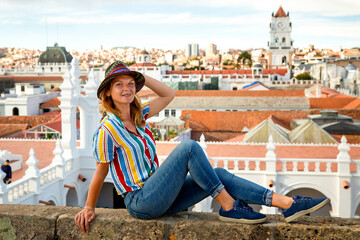 Girl tourist in a hat on the background of the city of Sucre, Bolivia.