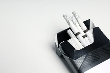 Concept of harm of smoking, pack of cigarettes on white background