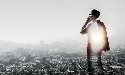 Concept of business success and control with confident boss against cityscape background