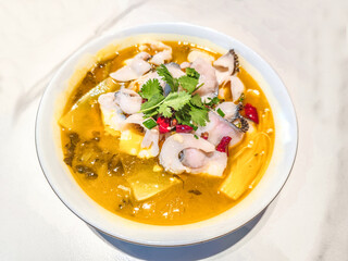 A dish of sauerkraut fish in golden soup