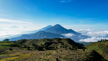 Fototapeta na wymiar Aerial view of beauty mountain peaks Prau Dieng, Central Java and the climbers and tent. 