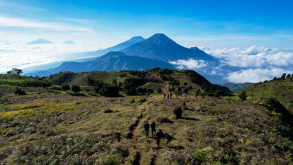 Aerial view of beauty mountain peaks Prau Dieng, Central Java and the climbers and tent. 