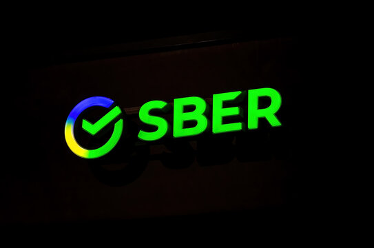 Signboard with the logo of the Sber Bank in the night