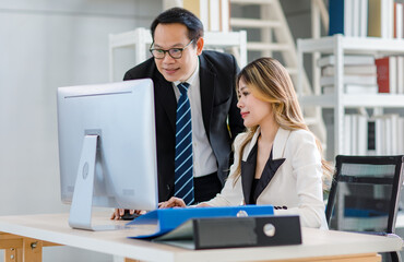 Millennial Asian young successful professional female businesswoman trainee sitting typing keyboard...