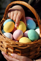 brightly coloured easter eggs in easter basket