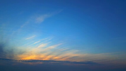 Panoramic fiery golden cirrus clouds on blue gradient sky. Heaven hell concept