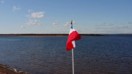 Aerial drone shot fly around Acadian flag Acadie Canada Francis.
