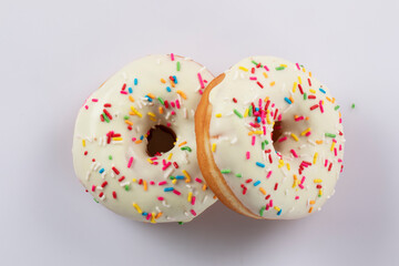 Traditional American donuts. flying over white background.