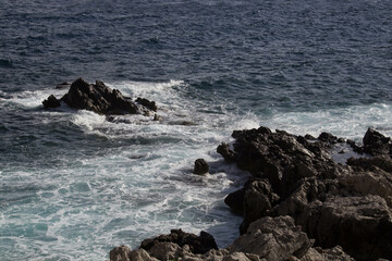 Fototapeta premium evocative image of a rough sea hitting the rocks in Sicily 