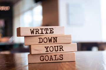 Wooden blocks with words 'Write Down Your Goals'.