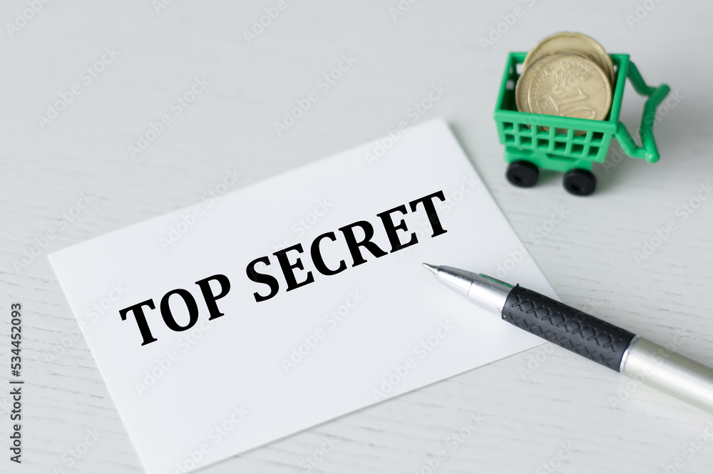 Poster top secret text on a card on a table next to a pen and coins