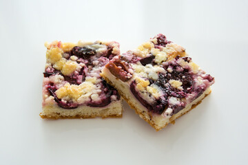 Sweet freshly baked plum pie lies on a white table