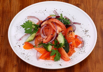 cucumber tomato salad on white plate