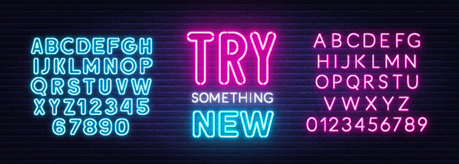 Try something new neon quote on a brick wall.