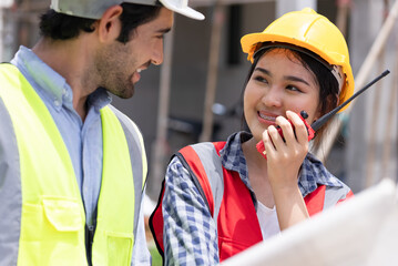 Mechanical Engineer team Working with paper work on construction home building site