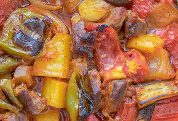 Top view of Turkish dish Guvech - baked meat with eggplant and traditionally served in earthenware pot (Turkish name; etli patlican guvec)