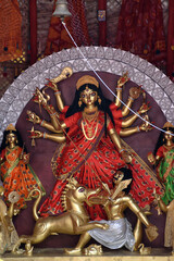 Idol of Goddess Devi Durga at a decorated puja pandal in Kolkata, West Bengal, India. Durga Puja is...