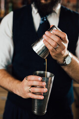 close up of barman holding shaker