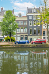 Typical Houses on the Amsterdam Canal and Cars