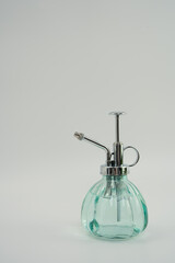 glass spray bottle on white background