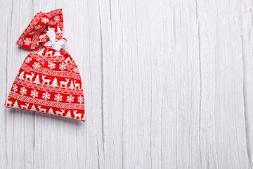Fototapeta premium christmas bag with gifts on a wooden background