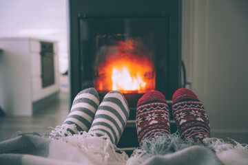 Feet woollen socks by fireplace