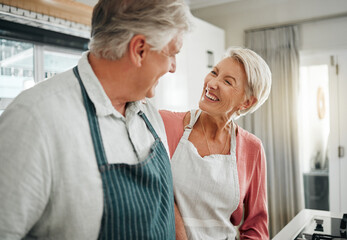 Couple, cooking and love with a senior man and woman in the kitchen to prepare food or a meal at...