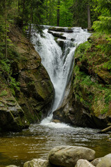Fototapeta na wymiar small waterfall in the mountain forest 