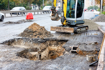 Repair of sewer manholes on the carriageway of the city road. - obrazy, fototapety, plakaty