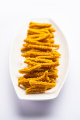 Bhajni chakli sticks or crunchy murukku snack made using diwali festival, favourite munching food