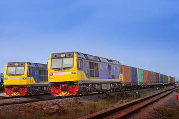 Fototapeta na wymiar Container-freight train by diesel locomotive in the railway yard