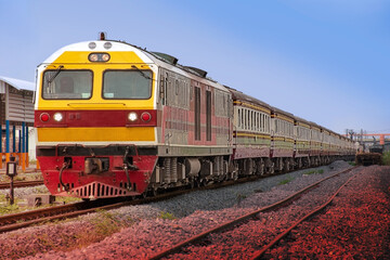 Fototapeta premium Passenger train by diesel locomotive at the railway station. 