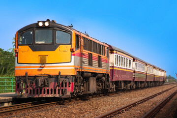 Passenger train by diesel locomotive at the railway station. 