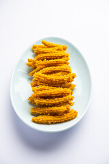 Bhajni chakli sticks or crunchy murukku snack made using diwali festival, favourite munching food