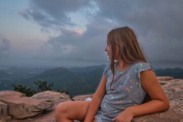 portrait of a girl against the sky and mountains