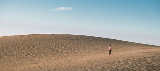 Young men walking at the beach of Maspalomas Gran Canaria Spain, young men walking in de sand...