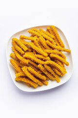 Bhajni chakli sticks or crunchy murukku snack made using diwali festival, favourite munching food