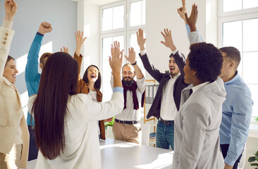 Success and teamwork: Diverse multiracial team of happy excited business people standing around...