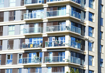Facade building. Residential building with balconies and windows. Facade Apartment house. House with window and balcony. Buildings architecture and home facade. Modern minimalistic architecture.
