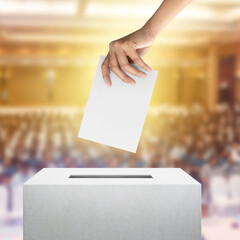 Election vote, hand holding ballot paper for election vote concept at convention hall background.
