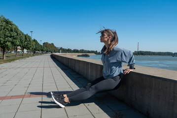 Young woman cancer survivor decides to change her way of life after illness and start practicing every morning as new life routine. Female workout training outdoor for health and happiness.